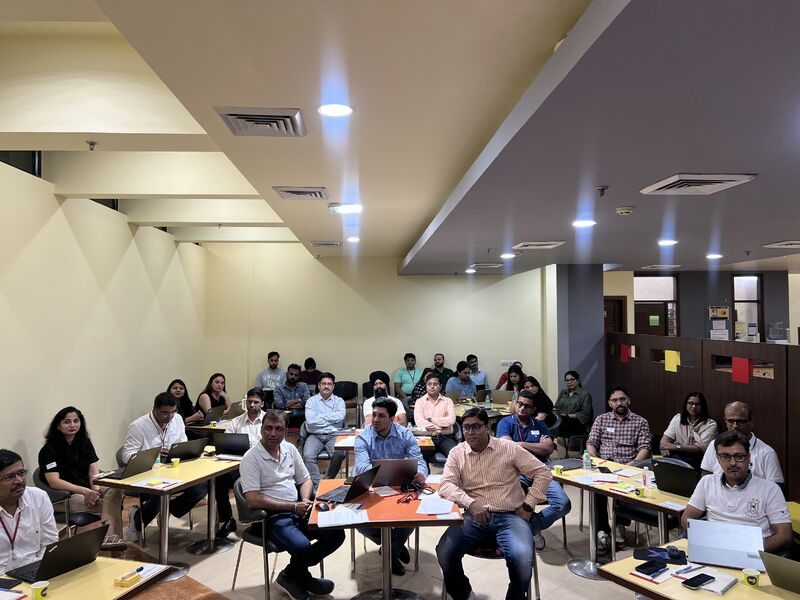 Damco delivery managers seated in a workshop hall