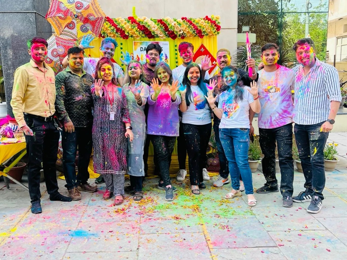 Damco colleagues covered in Holi colors outside the office