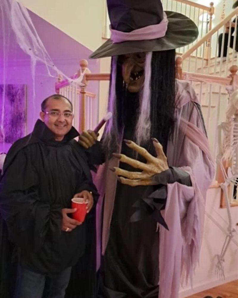 Manish Chugh next to a Halloween decoration