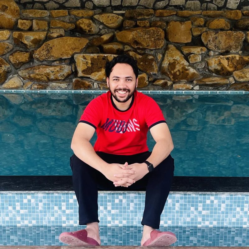 Vivek Rawat sitting by a pool