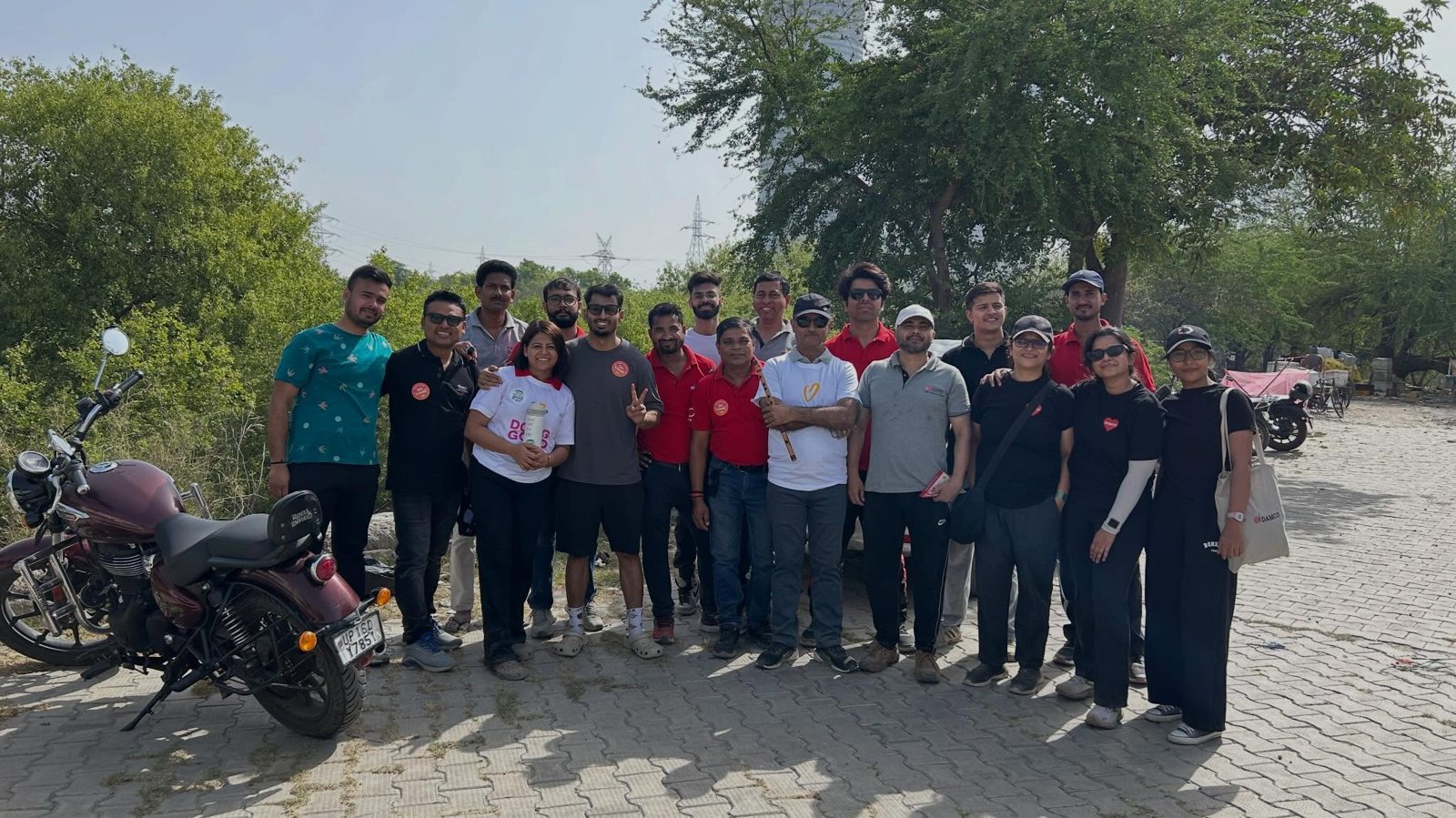 Damco volunteers with gloves and bags after a riverbank cleanup