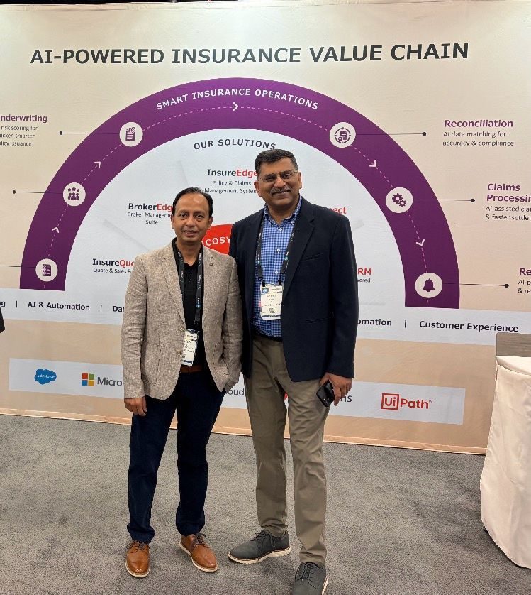 Two Damco leaders in front of an insurance value chain display