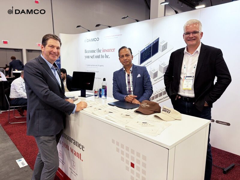 Damco's insurance team talking with an insurer at their booth