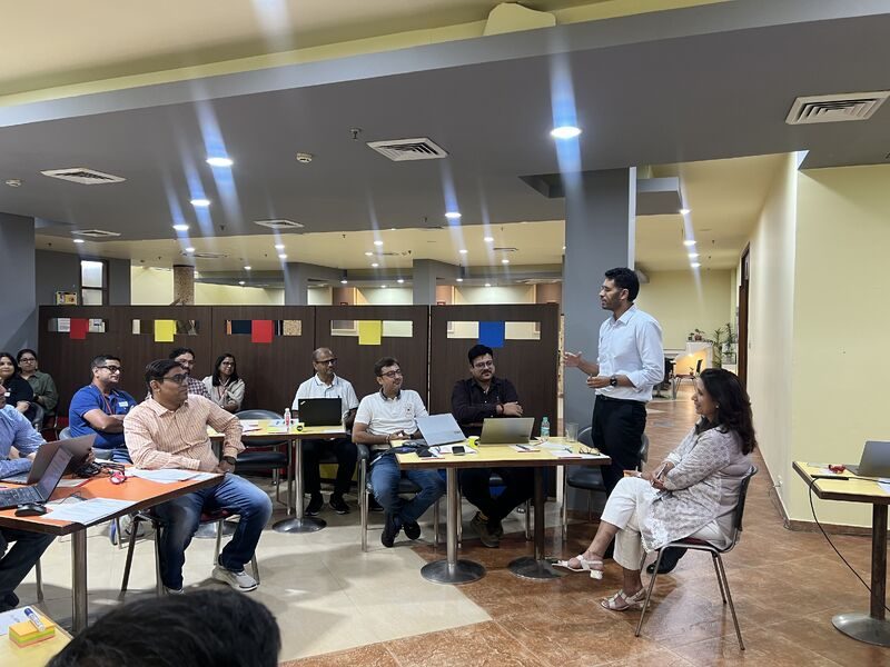 A Damco team at tables during a workshop